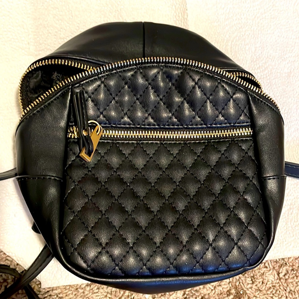Tiny black and gold mini backpack